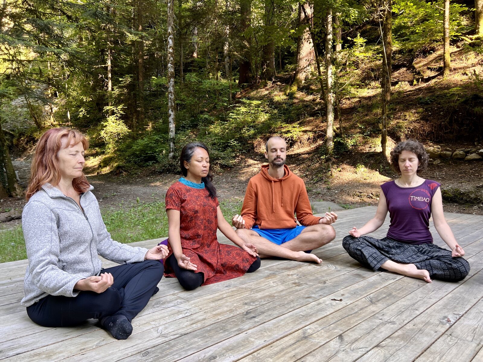 Participants meditating in the forest during an Alexandra Kalinine workshop